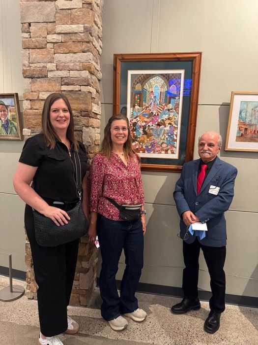Gallery guests with artwork